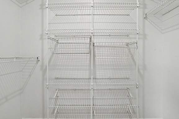 A walk-in closet with wardrobe organizers at Pine Knoll Apartments, Battle Creek
