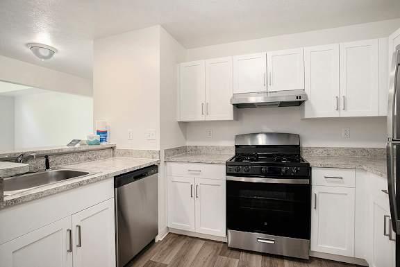 A kitchen with white cabinets and stainless steel appliances A kitchen with white cabinets and stainless steel appliances at Pine Knoll Apartments, Battle Creek, 49014