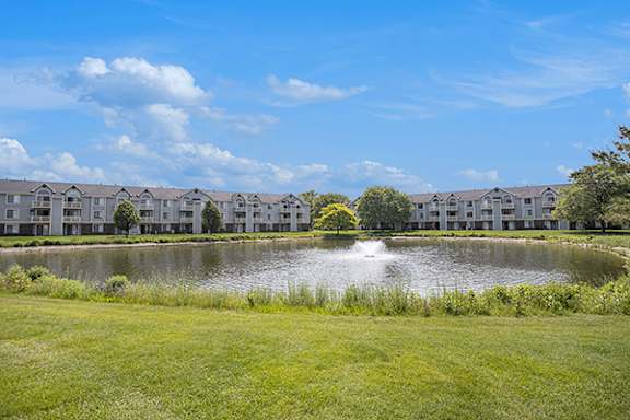 Serene Pond with Fountain at Pine Knoll Apartments in Battle Creek, MI