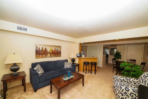 a living room with a couch and a table  at Pine Knoll Apartments, Battle Creek, MI