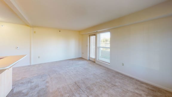 the living room of a home with a large window and a door  at Hunters Pond Apartment Homes, Champaign, IL, 61820