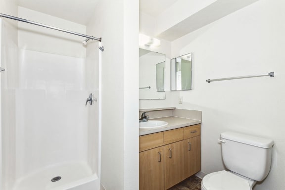 a bathroom with a toilet sink and a shower  at Hunters Pond Apartment Homes, Champaign, IL
