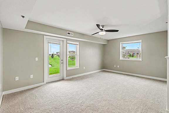 End style enlarged living room with extra window at The Reserve at Destination Pointe in Grimes, IA