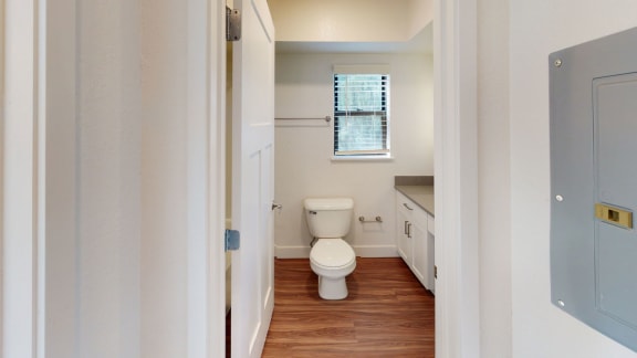 a bathroom with a toilet and a window at Green Ridge Apartments, Grand Rapids, MI