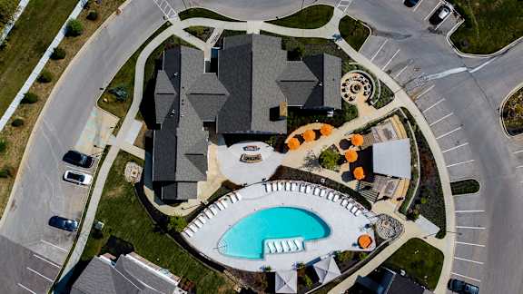 A large building with a pool in front of it. at River Crossing Apartments, St. Charles, Missouri
