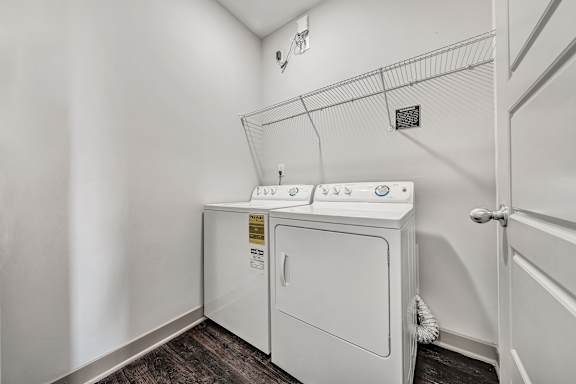 A white washer and dryer in a laundry room. at River Crossing Apartments, St. Charles, MO, 63303