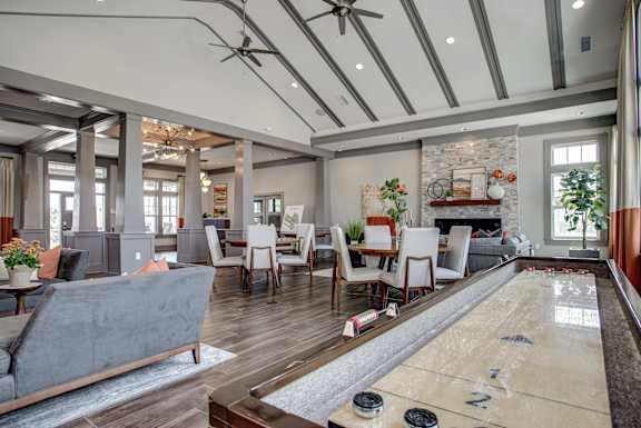 A room with a shiny wooden floor and a pool table. at River Crossing Apartments, St. Charles, 63303