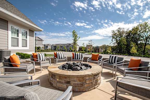 A patio with a fire pit and chairs. at River Crossing Apartments, St. Charles, 63303