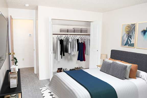 a bedroom with a closet full of clothes at Seville Apartments, Kalamazoo, MI, 49009