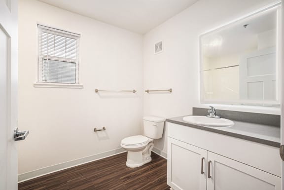 a bathroom with a window and a lighted mirror  at Signature Pointe Apartment Homes, Athens, AL