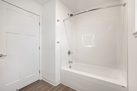 a bathroom with a shower and a tub at Signature Pointe Apartment Homes, Athens, Alabama
