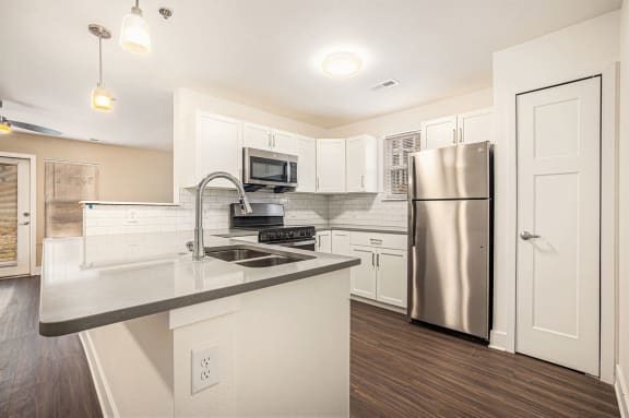 a modern kitchen with a window and stainless steel appliances  at Signature Pointe Apartment Homes, Athens, AL, 35611