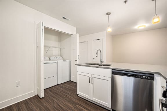 a kitchen with a full-size washer and dryer  at Signature Pointe Apartment Homes, Athens, 35611
