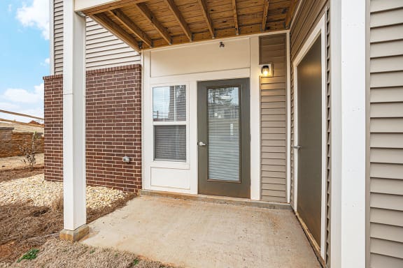 Private patio with a door to enclosed storage  at Signature Pointe Apartment Homes, Alabama, 35611