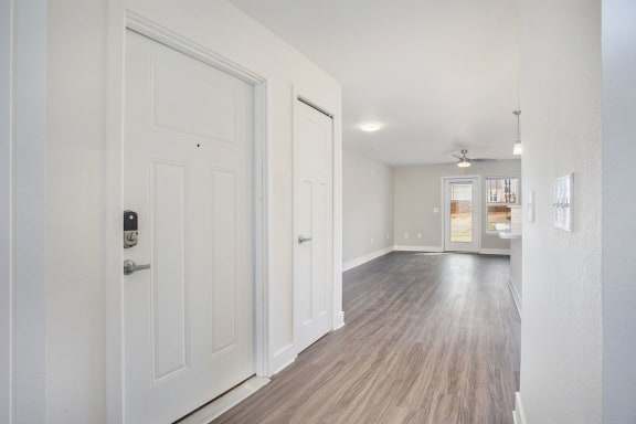 Entry hallway with wood floors leading to living room  at Signature Pointe Apartment Homes, Athens, 35611