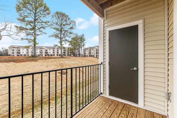 Private balcony with enclosed storage overlooking apartment community  at Signature Pointe Apartment Homes, Athens, AL, 35611