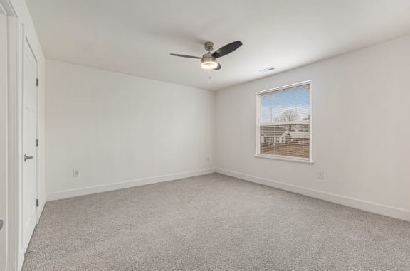 Large bedroom with a ceiling fan and a window  at Signature Pointe Apartment Homes, Athens