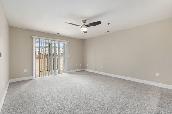 living room with a ceiling fan and a slider to a balcony  at Signature Pointe Apartment Homes, Athens, 35611