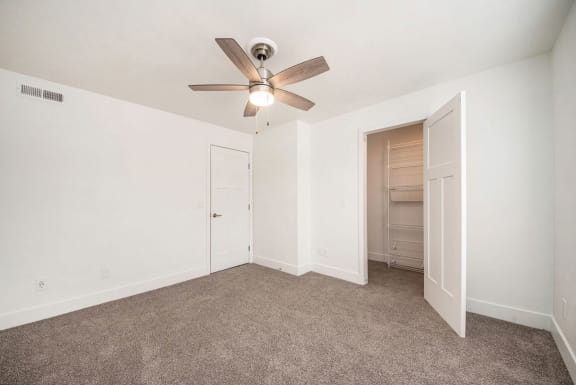 Bedroom with a ceiling fan and a walk in closet  at Signature Pointe Apartment Homes, Alabama