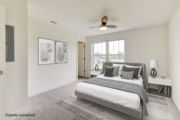 a bedroom with a bed and a ceiling fan at Stoney Pointe Apartment Homes, Kansas