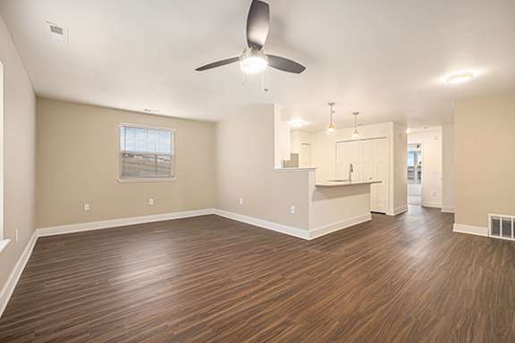 An enlarged living room with a ceiling fan and hard-surface flooring at Signature Pointe Apartment Homes, Athens