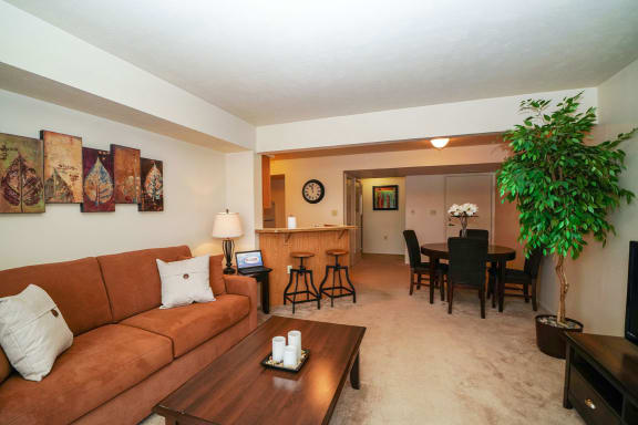 a living room and dining room with a couch and a table at South Bridge Apartments, Indiana, 46816