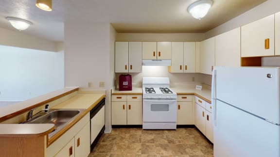 a kitchen with white appliances and white cabinets at South Bridge Apartments, Indiana, 46816