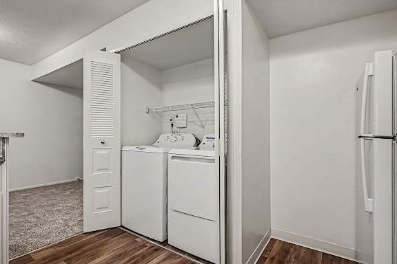 A white laundry room with a washer and dryer.