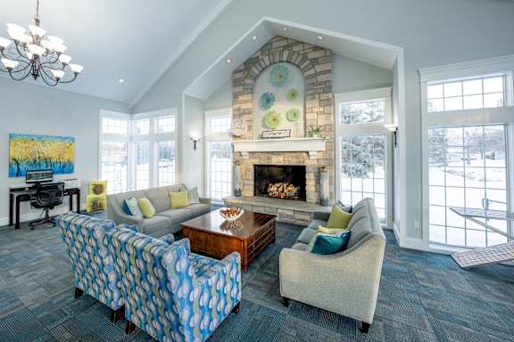 A living room with a fireplace and a painting on the wall.