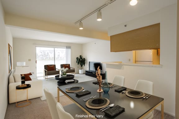 a living room and dining room with a table and chairs at The Springs Apartment Homes, Novi