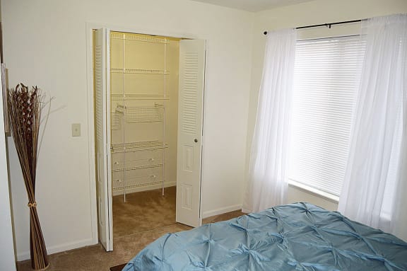 a bedroom with an empty closet and a bed at Stoney Pointe Apartment Homes, Wichita, KS, 67226