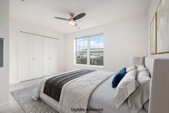 a bedroom with a large window and a ceiling fan at Stoney Pointe Apartment Homes, Wichita, 67226