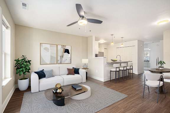 a living room with a ceiling fan and hard-surface flooring at Stoney Pointe Apartment Homes, Kansas