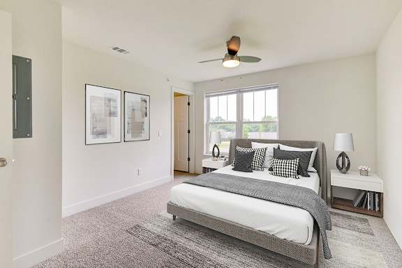 a bedroom with a bed and a ceiling fan at Stoney Pointe Apartment Homes, Kansas