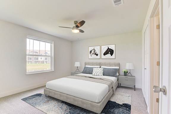 a bedroom with a bed and a ceiling fan at Stoney Pointe Apartment Homes, Wichita, 67226
