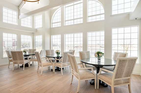 A dining room with a table and chairs.