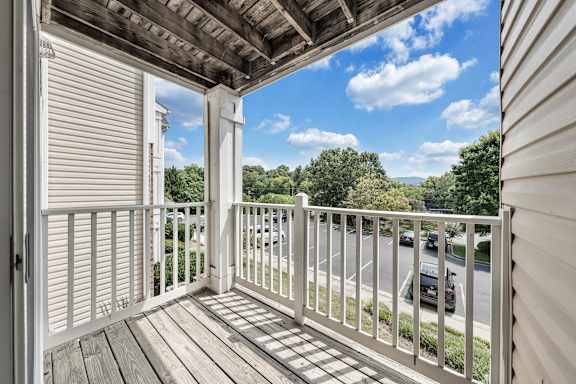 A balcony with a white railing and a view of the street below. at Sunscape Apartments, Virginia, 24018