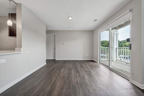 A room with a sliding glass door leading to a balcony. at Sunscape Apartments, Roanoke