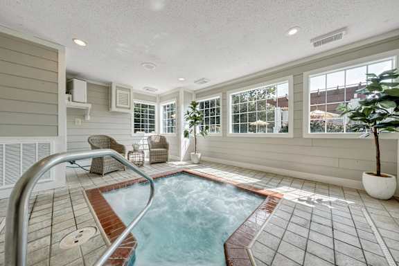 A small indoor pool with a metal ladder. at Sunscape Apartments, Virginia