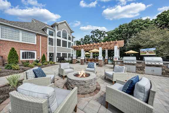 A patio with a fire pit and seating area. at Sunscape Apartments, Virginia, 24018