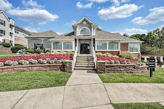 A house with a front yard and a sign that says  at Sunscape Apartments, Virginia, 24018