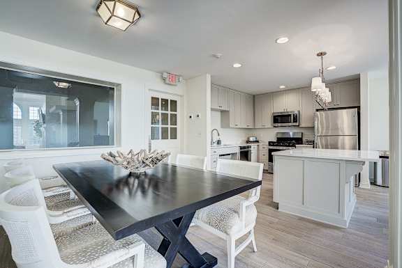 A modern kitchen with a dining table and chairs. at Sunscape Apartments, Roanoke, VA, 24018
