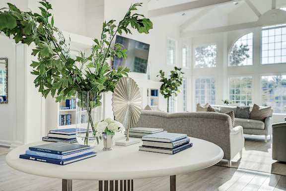 A living room with a white table and a plant on it. at Sunscape Apartments, Roanoke