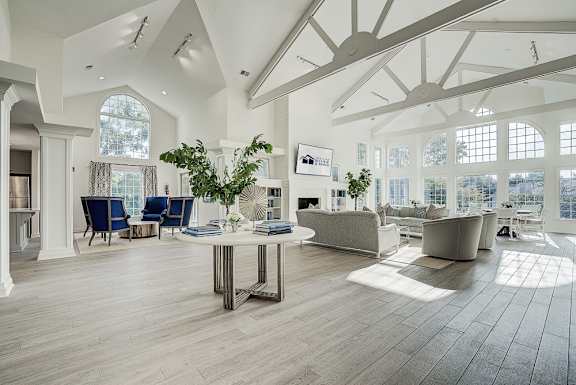 A spacious living room with a large table and chairs. at Sunscape Apartments, Virginia
