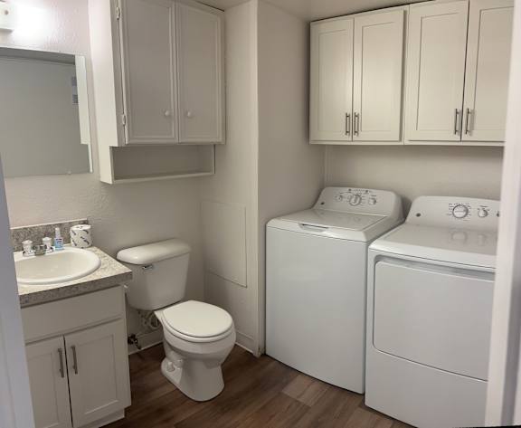 A white toilet sits next to a sink in a small bathroom