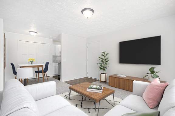 A living room with a white couch, a wooden coffee table, and a dining room at Swiss Valley Apartments in Wyoming, MI