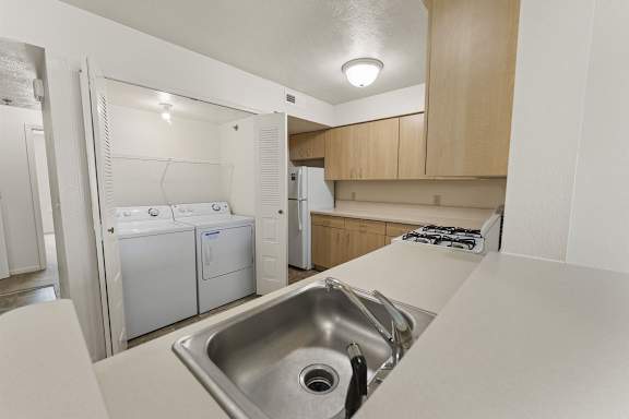 A kitchen with a washer and dryer at Tall Oaks Apartment Homes, Kalamazoo, MI, 49009