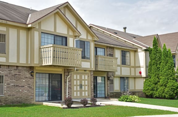 a building with two balconies and a sidewalk in front of it at Tanglewood Apartments, Oak Creek