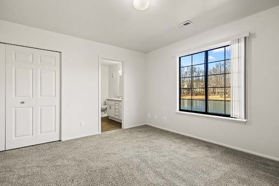 A bedroom with an ensuite bathroom and a closet at Tanglewood Apartments, Oak Creek, WI