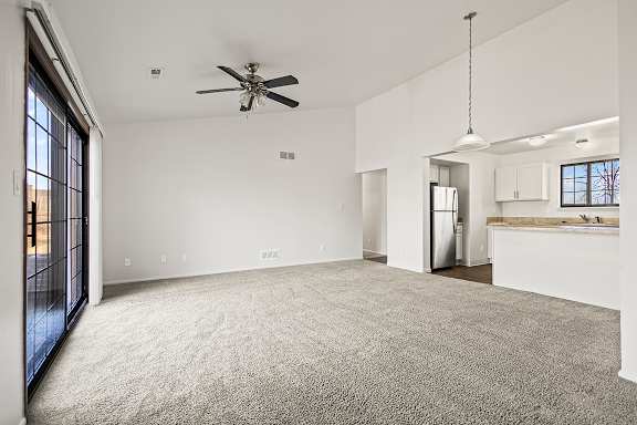 A spacious living room with a high ceiling and ceiling fan at Tanglewood Apartments, Oak Creek, WI